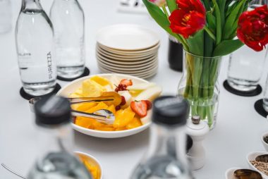 An elegant dining setup featuring fresh fruits and vibrant tulips, perfect for a healthy meal.
